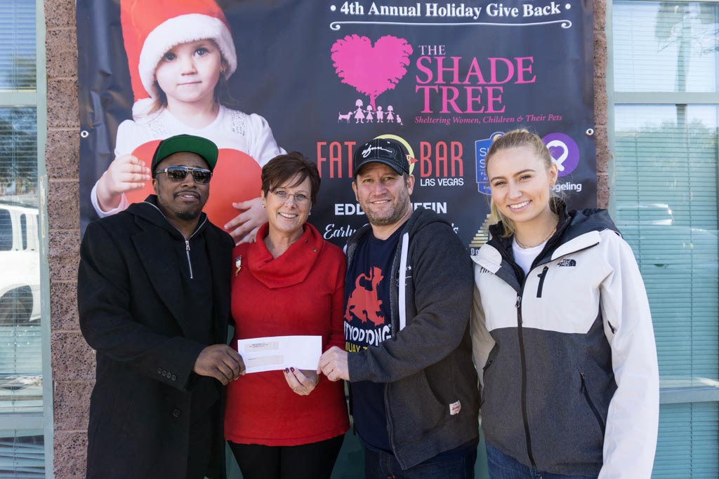 Eddie Griffin, Darin Feinstein, and supporters pose with a check for The Shade Tree.